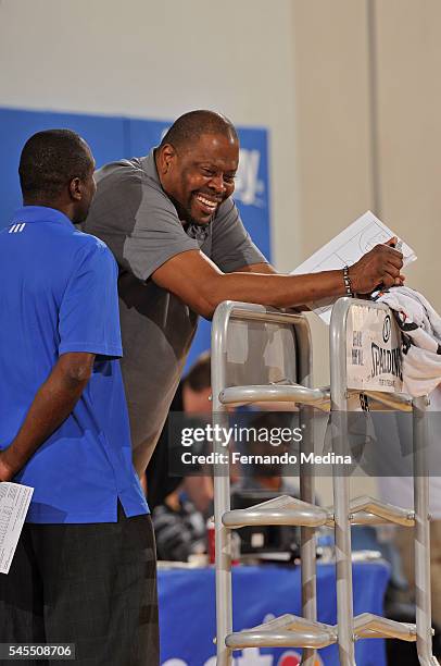 Patrick Ewing of the Charlotte Hornets smiles as he coaches against the Dallas Mavericks during the Orlando Summer League on July 8, 2016 at Amway...