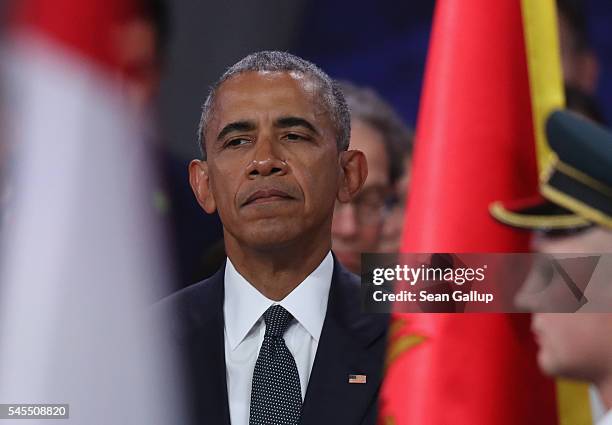 President Barack Obama observes a ceremony to honour NATO soldiers killed in the line of duty prior to the meeting of the North Atlantic Council at...