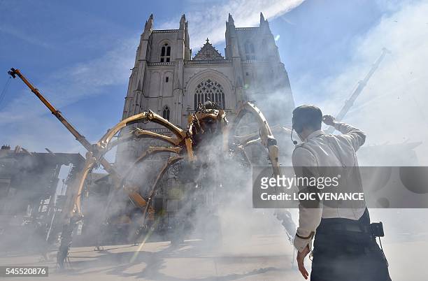 Men prepare to pilot Kumo, a mechanical spider made of wood and steel by "Les Machines de L'Ile" factory, presented to the public for the first time...
