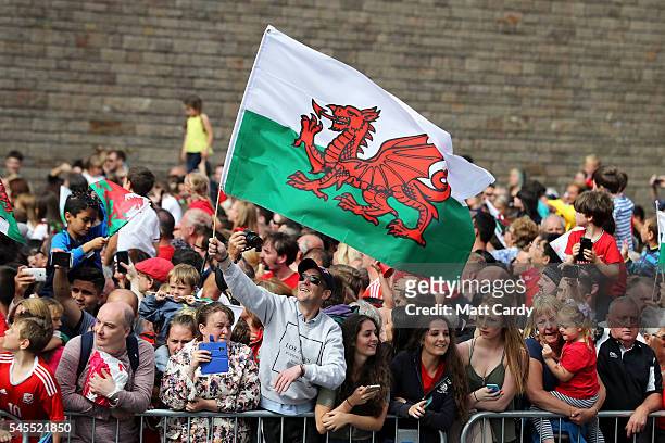 Fans cheer before the start of the parade as the Wales team are welcomed home following their exit from the Euro 2016 championships, on July 8, 2016...