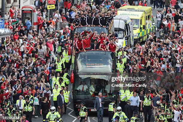 Fans cheer as they line Westgate Street to welcome the Wales team home following their exit from the Euro 2016 championships, on July 8, 2016 in...