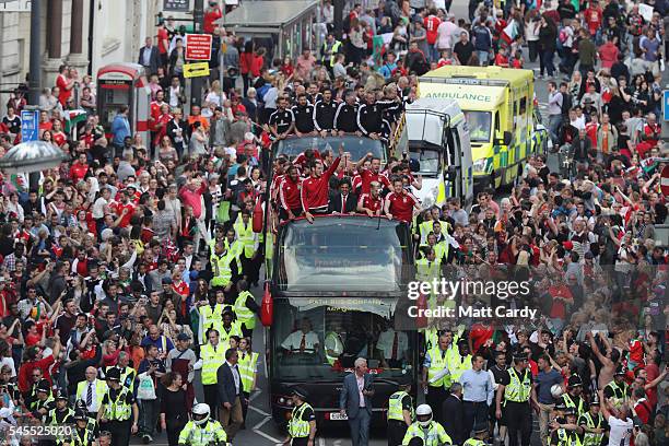 Fans cheer as they line Westgate Street to welcome the Wales team home following their exit from the Euro 2016 championships, on July 8, 2016 in...