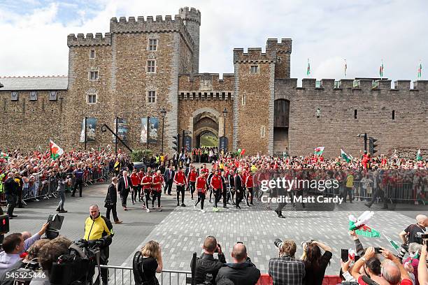 The Welsh team walk out of Cardiff Castle and are welcomed home by fans following their exit from the Euro 2016 championships, on July 8, 2016 in...