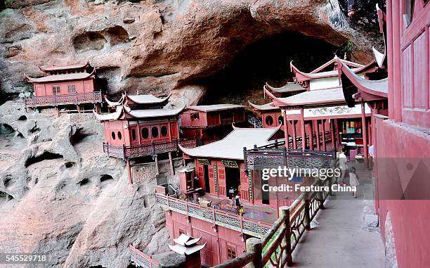 View of the Ganlu Temple, the major part of which is supported on a big wooden pole, in a valley in Taining county in southeast China's Fujian...