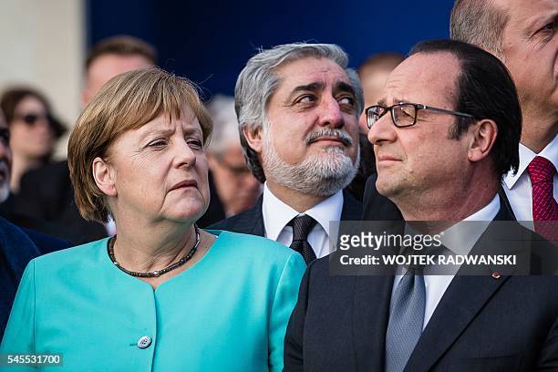 German Chancellor Angela Merkel, Afghanistan's Chief Executive Abdullah Abdullah and French President Francois Hollande attend the fly-past of NATO...