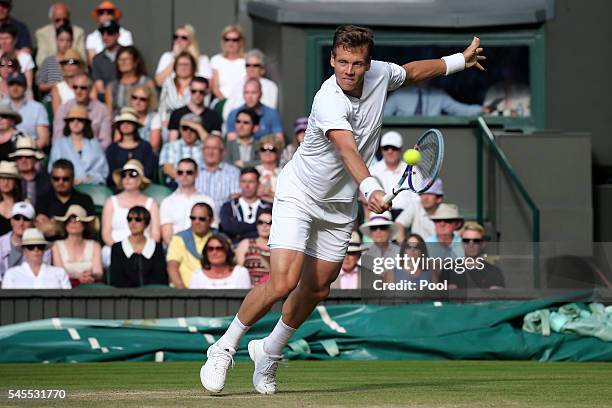 Tomas Berdych of The Czech Republic plays a backhand during the Men's Singles Semi Final match against Andy Murray of Great Britain on day eleven of...