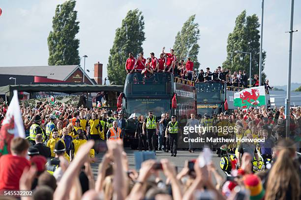 An open top bus carrying the Wales team arrives at the Cardiff City Stadium on July 8, 2016 in Cardiff, Wales. The players toured the streets of...