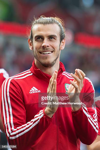 Wales' Gareth Bale performs for the crowd during a ceremony at the Cardiff City Stadium on July 8, 2016 in Cardiff, Wales. The players toured the...