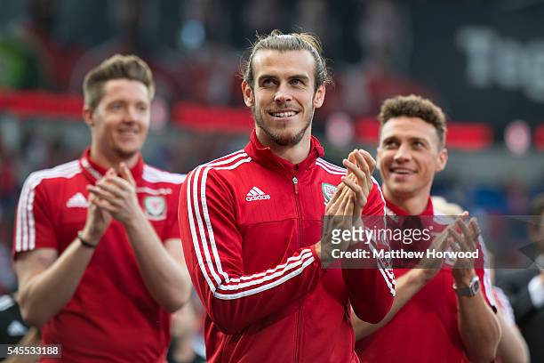 Wales' Gareth Bale with Wayne Hennessey and James Chester during a ceremony at the Cardiff City Stadium on July 8, 2016 in Cardiff, Wales. The...