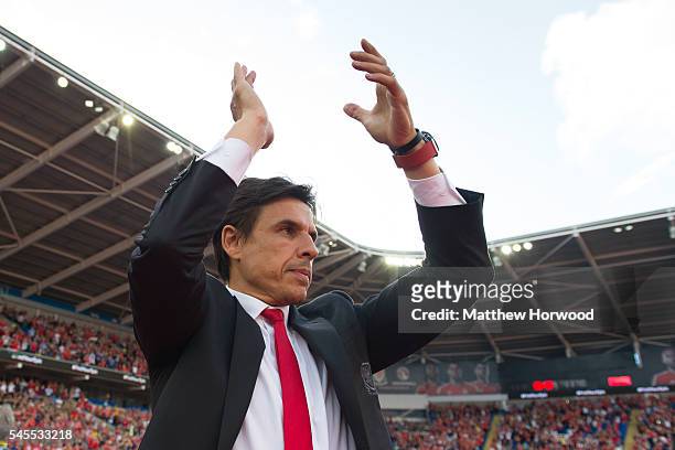 Wales' manager Chris Coleman claps during a ceremony at the Cardiff City Stadium on July 8, 2016 in Cardiff, Wales. The players toured the streets of...