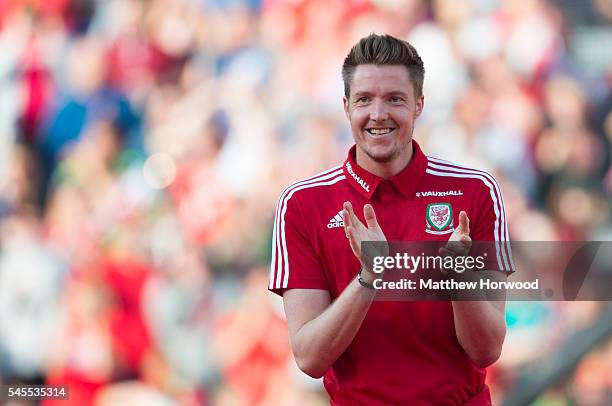 Wales' Wayne Hennessey claps during a ceremony at the Cardiff City Stadium on July 8, 2016 in Cardiff, Wales. The players toured the streets of...