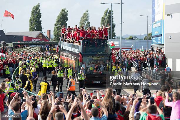 The Wales team arrive at the the Cardiff City Stadium on an open top bus on July 8, 2016 in Cardiff, Wales. The players toured the streets of Cardiff...