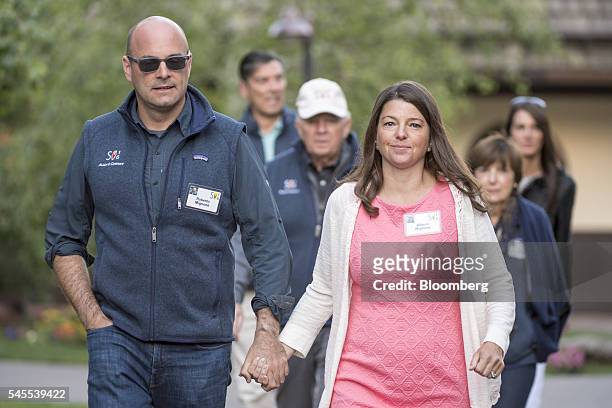 Roberto Mignone, managing partner for Bridger Management LLC, and his with his wife Allison Mignone arrive to the morning sessions during the Allen &...