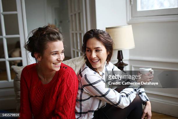 two friends laughing together - female friendship stock pictures, royalty-free photos & images