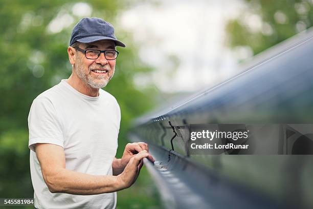 maintenance on the roof - goot stockfoto's en -beelden