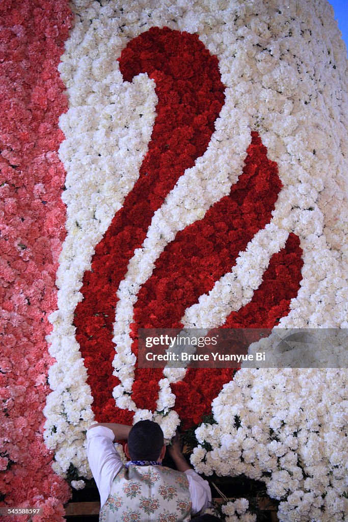 Decorating the statue of Virgin with flowers