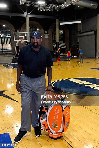 Assistant Coach Mike Woodson of the Los Angeles Clippers is presented a golf bag as he conducts the Woodson Basketball Youth Experience, an official...
