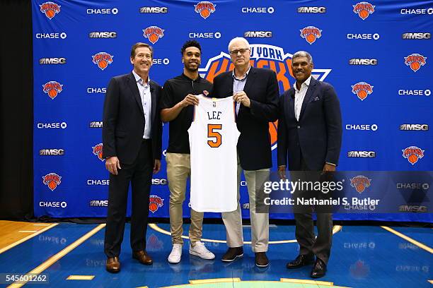 Courtney Lee poses with New York Knicks President Phil Jackson, General Manager Steve Mills, and Head Coach Jeff Hornacek at a press conference at...