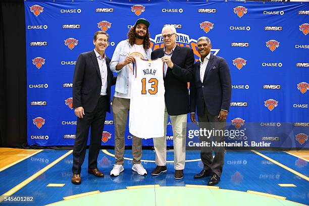 Joakim Noah poses with New York Knicks President Phil Jackson, General Manager Steve Mills, and Head Coach Jeff Hornacek at a press conference at the...