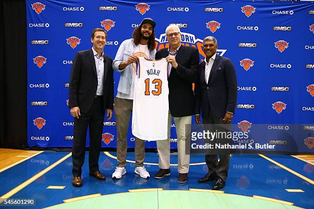 Joakim Noah poses with New York Knicks President Phil Jackson, General Manager Steve Mills, and Head Coach Jeff Hornacek at a press conference at the...