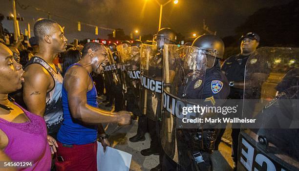 Protesters face off with Baton Rouge police in riot gear across the street from the police department on July 8, 2016 in Baton Rouge, Louisiana....