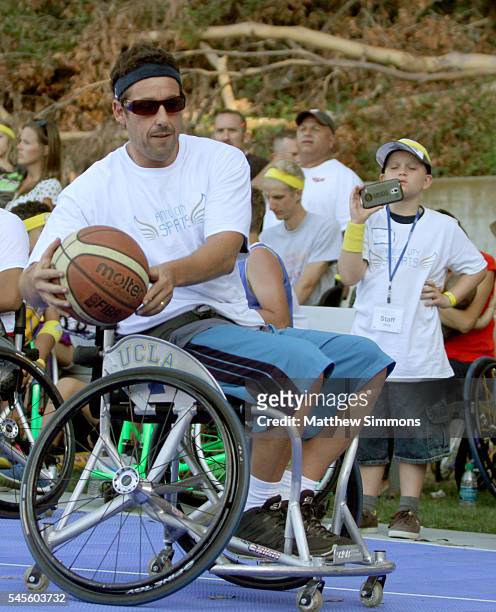 Comedian Adam Sandler plays in a celebrity wheelchair basketball game during the 2nd Annual Angel City Games at UCLA's Drake Stadium on July 8, 2016...