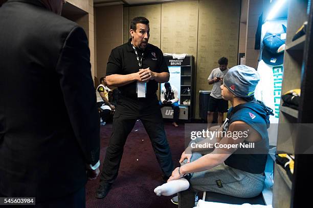 John McCarthy goes over the rules with Claudia Gadelha in her locker room before The Ultimate Fighter Finale at MGM Grand Garden Arena on July 8,...