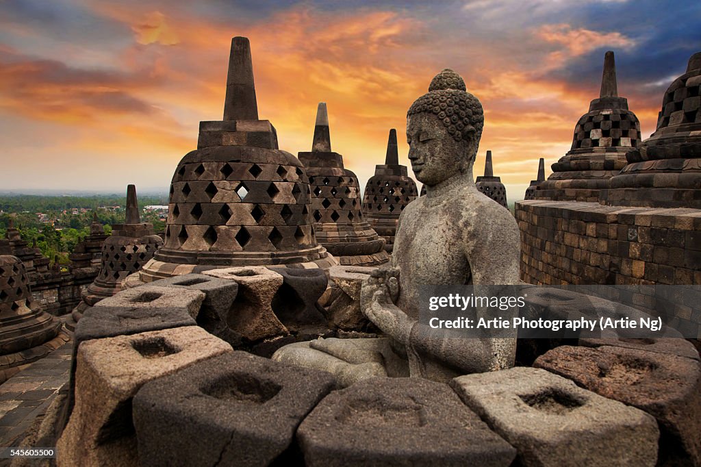 Sunrise with a Buddha Statue with the Hand Position of Dharmachakra Mudra in Borobudur, Magelang, Central Java, Indonesia