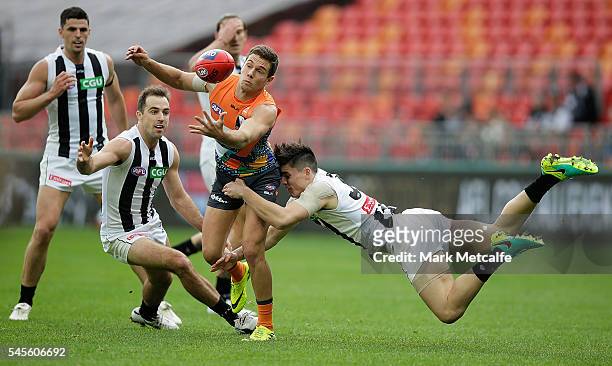 Josh Kelly of the Giants is tackled by Brayden Maynard of the Magpies during the round 16 AFL match between the Greater Western Sydney Giants and the...