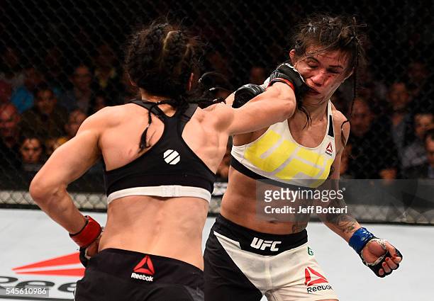 Joanna Jedrzejczyk of Poland punches Claudia Gadelha of Brazil in their women's strawweight championship bout during The Ultimate Fighter Finale...