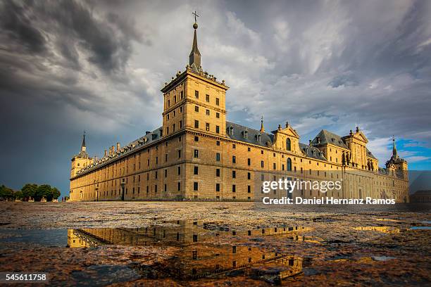 monasterio de el escorial with a dramatic light, and stormy clouds. madrid. spain - el escorial stock pictures, royalty-free photos & images