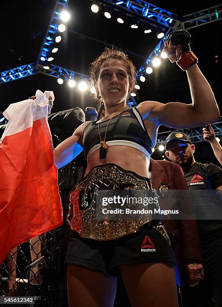 Joanna Jedrzejczyk of Poland celebrates after her victory over Claudia Gadelha in their women's strawweight championship bout during The Ultimate...