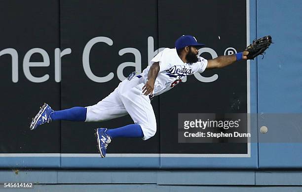 Center fielder Andrew Toles of the Los Angeles Dodgers dives but can't reach a double hit by Yangervis Sarte of the San Diego Padres in the sixth...