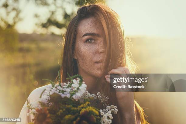 artistic portrait of freckled woman - tierkopf stock-fotos und bilder