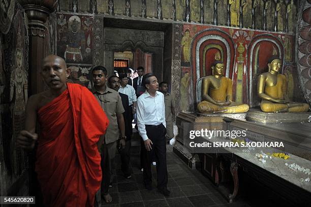 Chinese Foreign Minister Wang Yi looks on during a visit to the Kelaniya Rajamaha temple in Kelaniya on July 9, 2016. Wang Yi is in Sri Lanka for a...