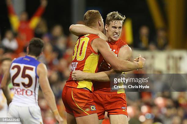 Peter Wright of the Suns celebrates a goal with team mate Tom Lynch during the round 16 AFL match between the Gold Coast Suns and the Brisbane Lions...