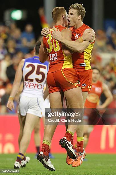 Peter Wright of the Suns celebrates a goal with team mate Tom Lynch during the round 16 AFL match between the Gold Coast Suns and the Brisbane Lions...