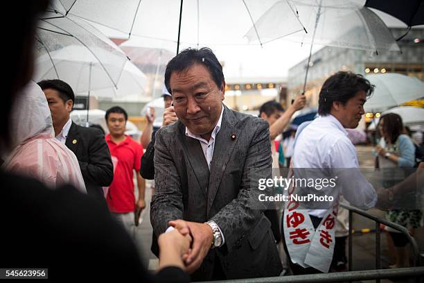 Yoshihiko Noda a former Prime Minister and member of the Democratic Party of Japan greets supporters after a campaign speech for candidate Hiroyuki...