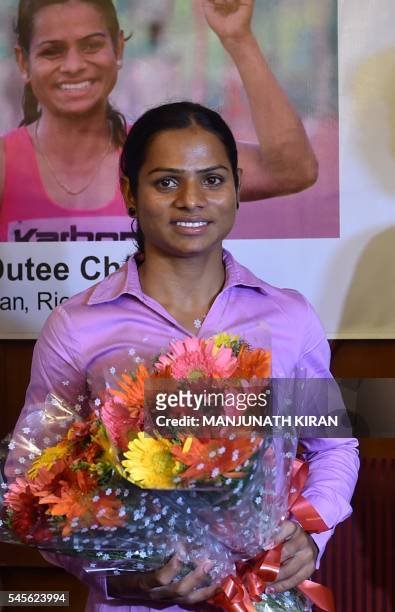 Indian sprinter Dutee Chand, who has qualified for the Women's 100 meters event at the Summer Olympic Games, poses for a photograph during a press...