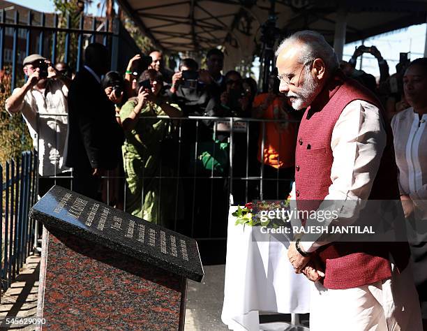 Indian Prime Minister Narendra Modi reads a plaque at the Pietermaritzburg railway station some 90 kilometres north of Durban on July 9, 2016. Indian...