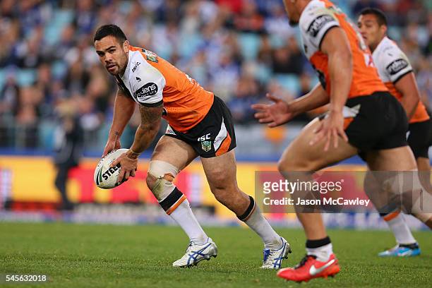 Dene Halatau of the Tigers looks to pass during the round 18 NRL match between the Canterbury Bulldogs and the Wests Tigers at ANZ Stadium on July 9,...