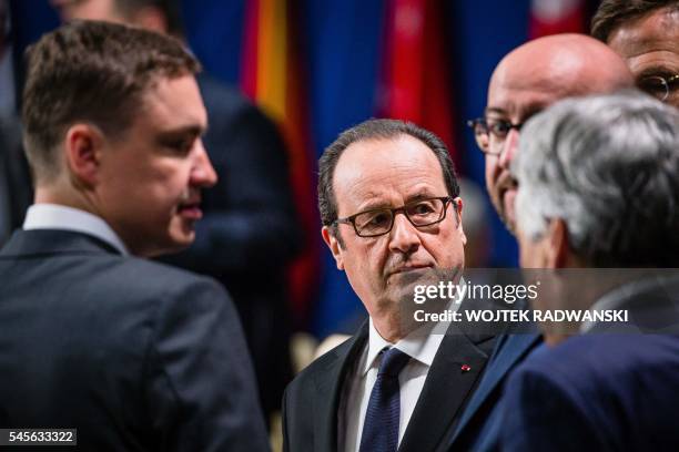 French President Francois Hollande is seen talking with Estonian Prime Minister Taavi Roivas and Belgium's Prime Minister Charles Michel and...