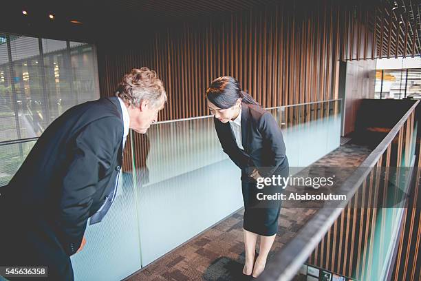 senior caucasian businessman and young japanese entrepreneur bowing, kyoto, japan - woman bowing stock pictures, royalty-free photos & images