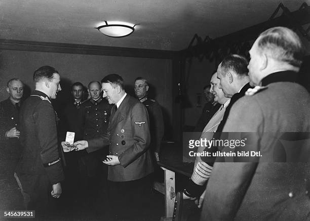 Hans-Ulrich Rudel, officer, colonel, Germany - Adolf Hitler handing the "Goldene Eichenlaub" to him at head quarter "Adlerhorst", f.r.: Karl Doenitz,...
