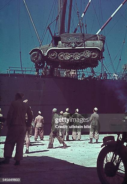 World War II North African Campaign: Unloading a half-track vehicle on a ship near Tripolis - summer 1941 - Photographer: Wolff & Tritschler -...