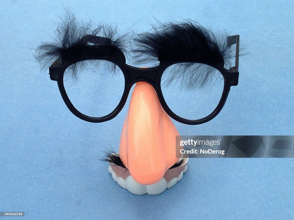 Big nose, bushy eyebrows and funny teeth face around eyeglasses