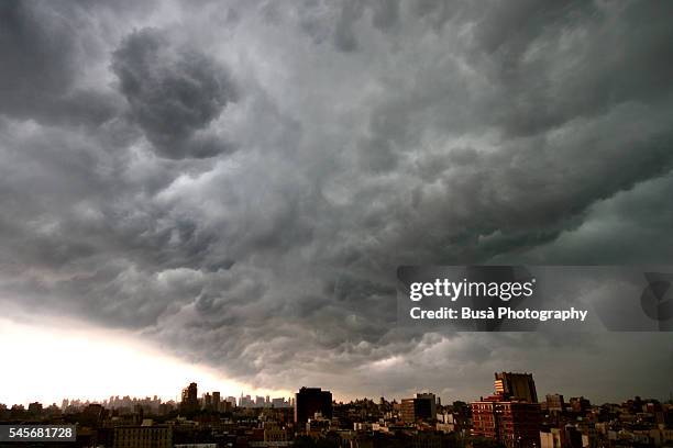 summer storm on the roofs of harlem - hurricane storm stock pictures, royalty-free photos & images