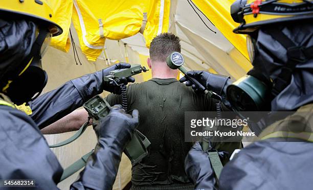 Fussa, Japan - Members of the U.S. Marine Chemical Biological Incident Response Force take part in a drill at Yokota Air Base in Tokyo on April 9...