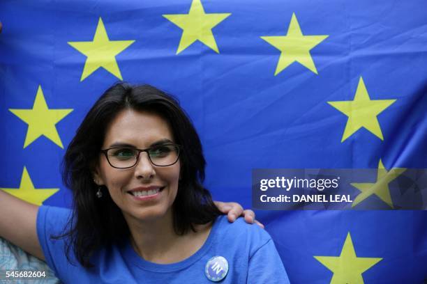Woman smiles in front of a European Union flag during a picnic against Brexit organised by the General Assembly in Green Park in London on July 9,...