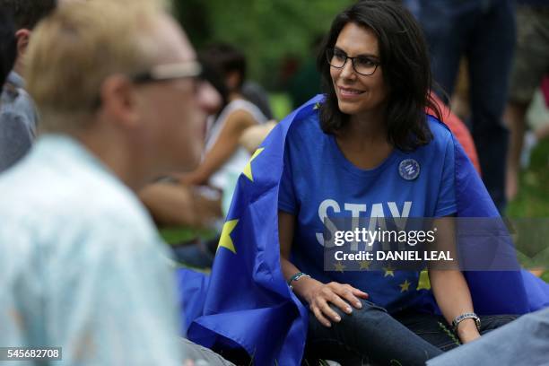 Woman wearing a "Stay" T-shirt smiles, draped in a European flag during a picnic against Brexit organised by the General Assembly in Green Park in...